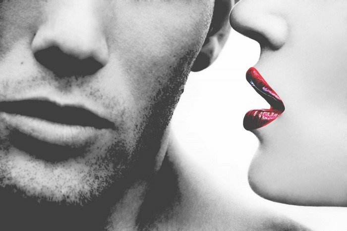 Man and woman whispering secrets