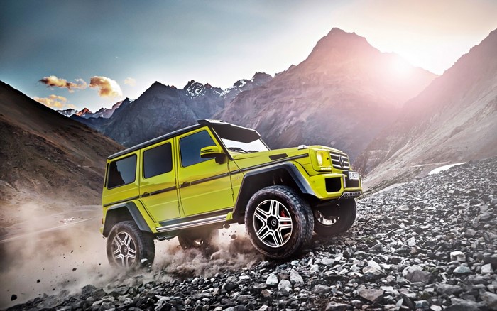 Yellow Mercedes G-Wagon off-roading in mountains
