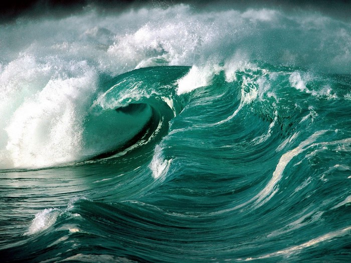 Crashing ocean waves under a dark sky