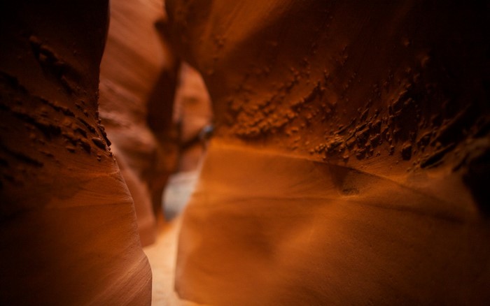 Sunlight filtering through a narrow sandstone canyon