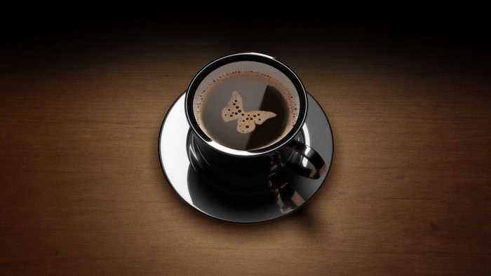 Coffee cup with butterfly foam art