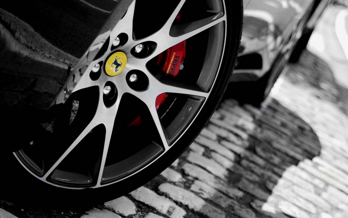 Ferrari wheel with red brake caliper