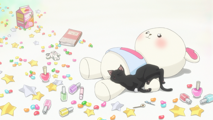 Black cat sleeping on a plush toy with scattered candy and nail polish
