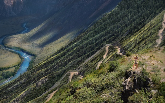 Woman on mountain overlooking river valley
