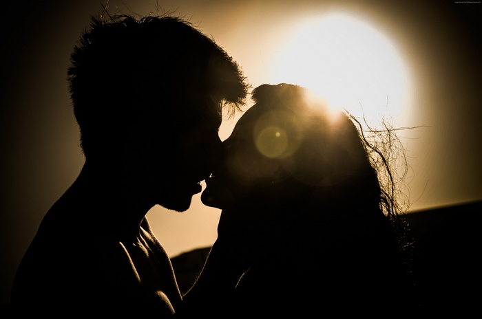 Couple kissing at sunset
