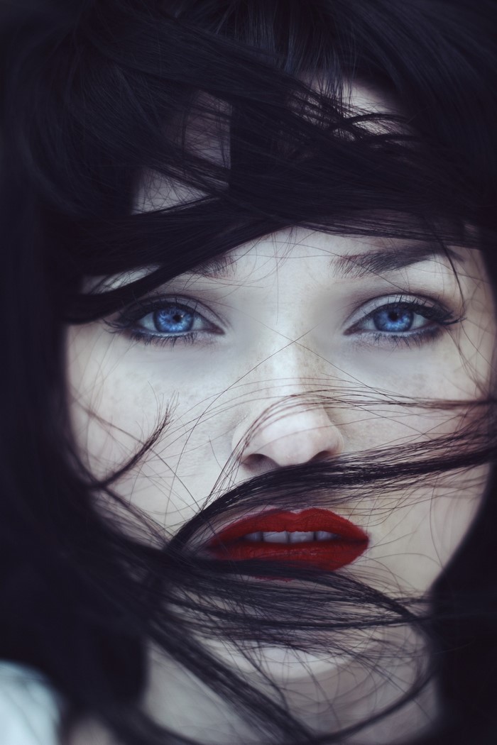 Close up portrait of a woman with blue eyes and red lipstick