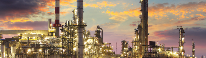 Industrial refinery at sunset with dramatic clouds
