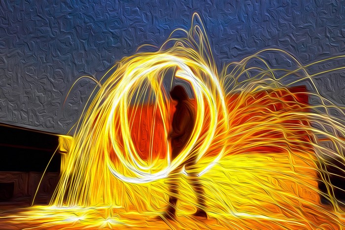 Person spinning steel wool creating a circle of sparks