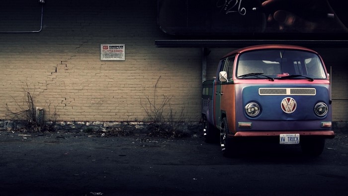 Volkswagen Bus Truck parked by brick wall
