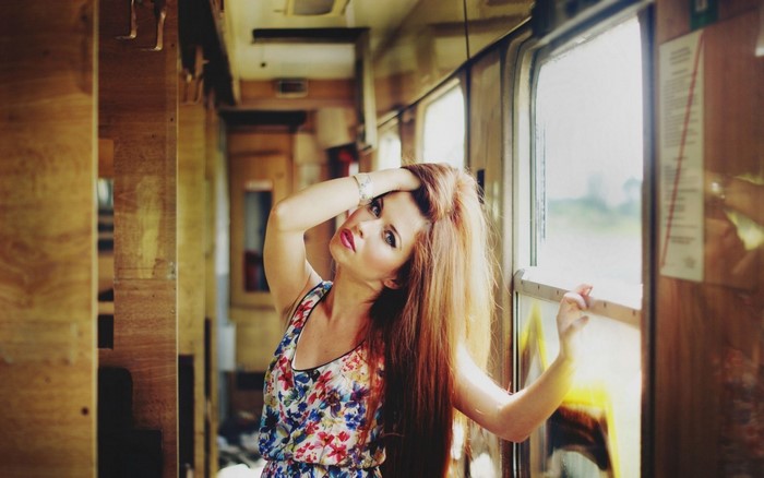 Woman in floral dress on a train