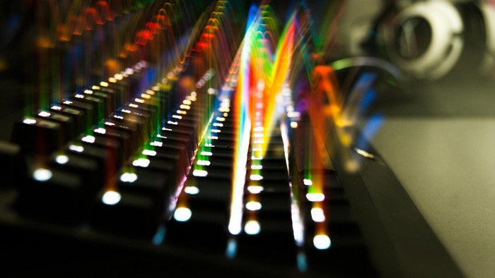 Keyboard with colorful light streaks and headphones
