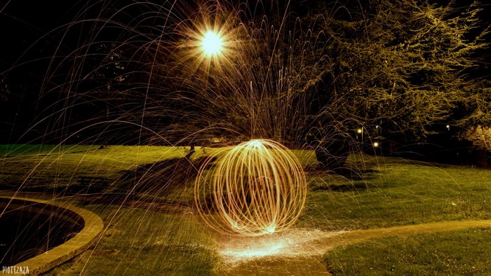 Light painting with sparks in a park at night