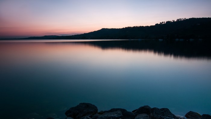 Lake at sunset with reflection and rocks