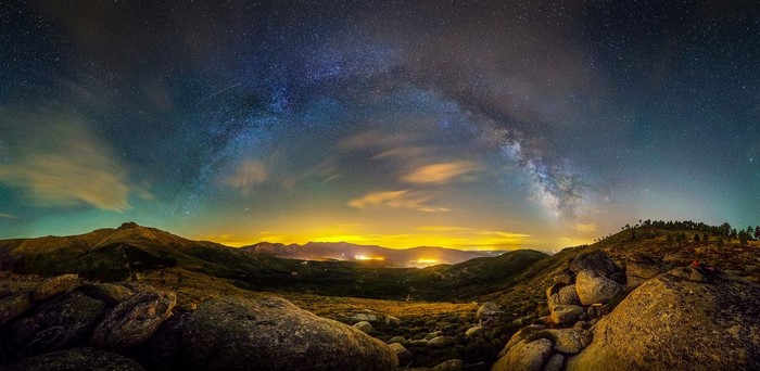 Milky Way over a mountainous landscape at night