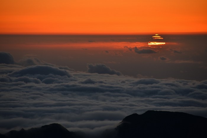 Sunset over clouds from a mountain peak