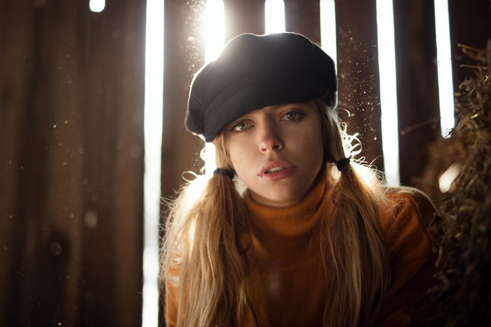 Woman wearing a black beret and orange turtleneck