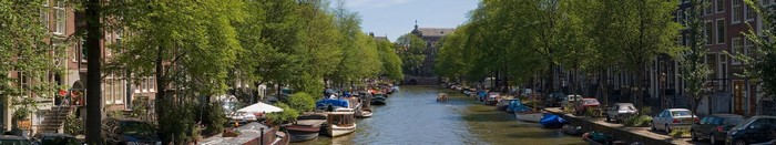 Amsterdam canal with boats and trees