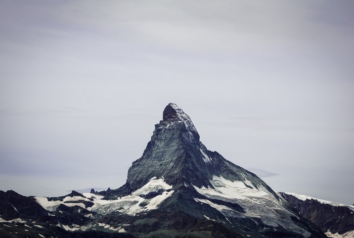 The Matterhorn mountain peak with snow and clouds
