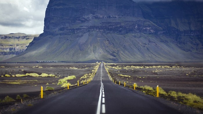 Road through Iceland landscape with large mountain