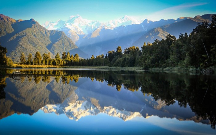 Mirror Lake Reflection of Snow-Capped Mountains and Forest