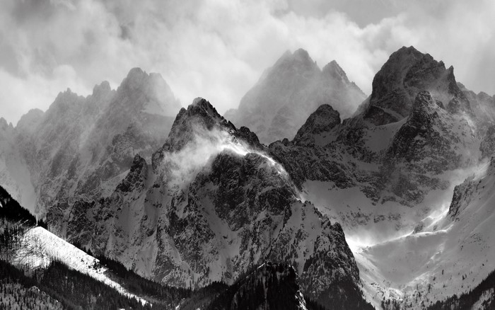 Monochrome mountain range with snow and mist