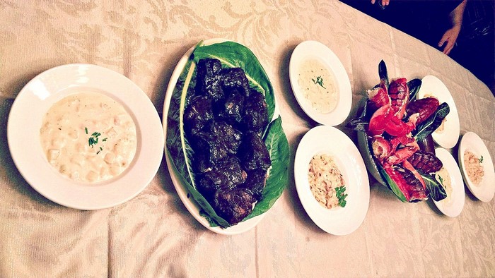 A table laden with seafood and other dishes