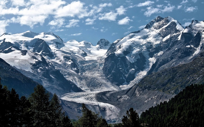 Snow-capped mountains and a glacier under a blue sky