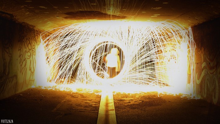 Person in a tunnel with steel wool light painting