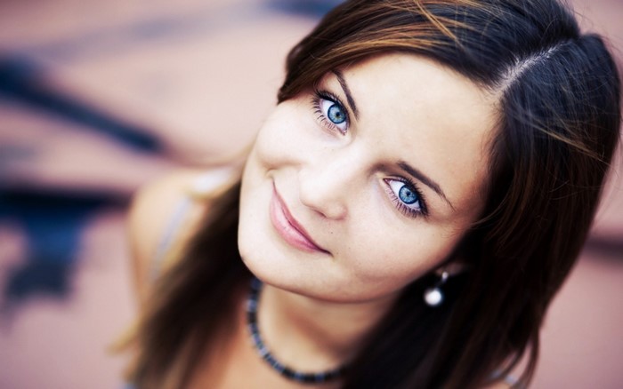 Close-up portrait of a woman with blue eyes and brown hair