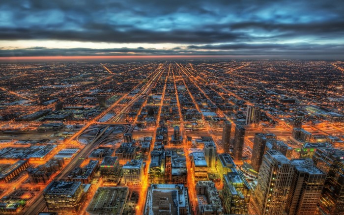 Aerial view of a city at dusk with glowing lights