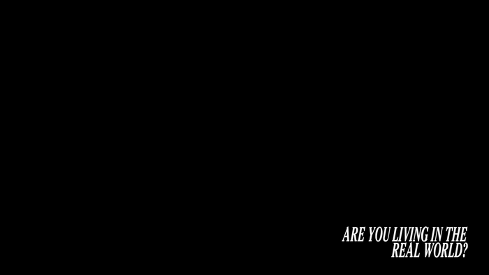 Text: ARE YOU LIVING IN THE REAL WORLD?