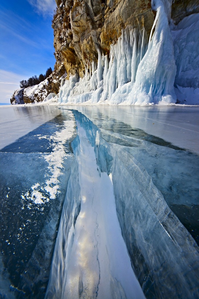 Frozen Lake Baikal with Icicles on Cliff