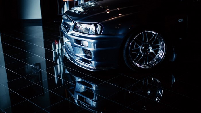 Nissan Skyline GT-R R34 sports car with custom wheels