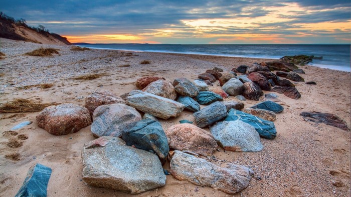 Rocky beach at sunset with ocean waves