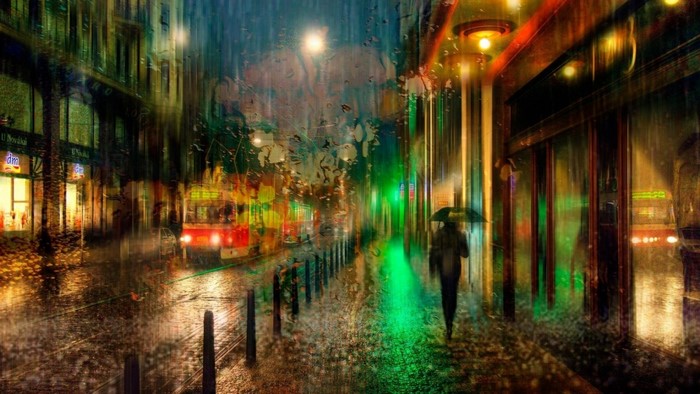 Rainy Night Cityscape with Tram and Umbrella
