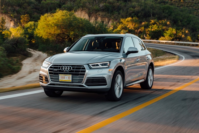 Silver Audi Q5 driving on a winding road