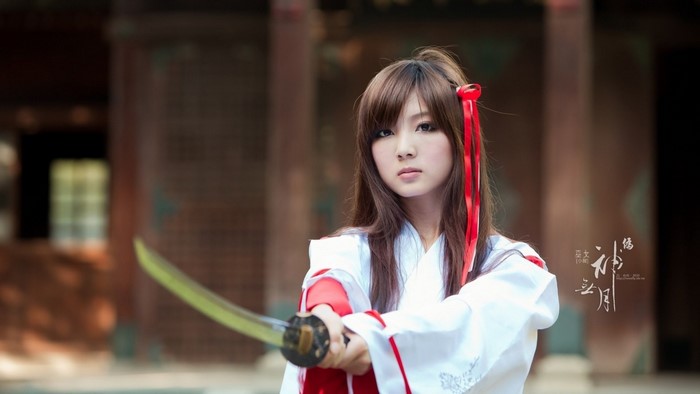 Woman in Traditional Japanese Kimono Holding Katana