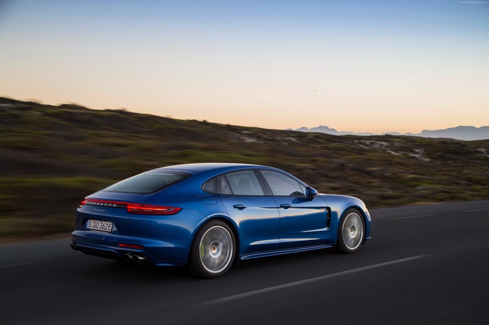Blue Porsche Panamera 4 E-Hybrid driving on road