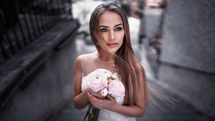 Woman holding pink flowers, portrait photography
