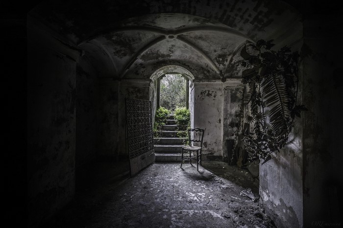 Abandoned building interior with stairs and chair