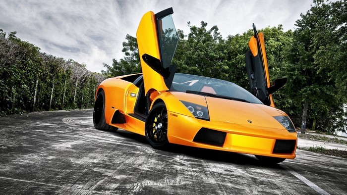 Orange Lamborghini Murcielago LP650-4 Roadster with doors open