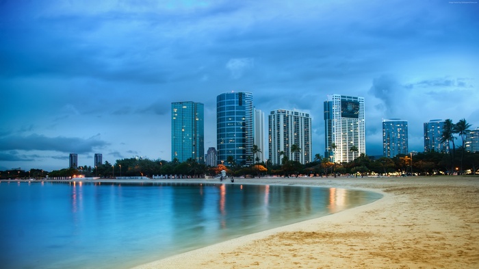 City skyline with beach and ocean at dusk