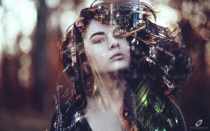 Double exposure portrait of a woman with city lights