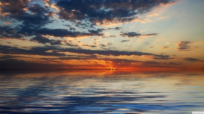 Sunset over the ocean with clouds