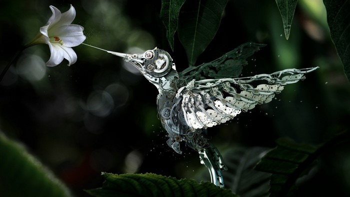 Mechanical hummingbird feeding from a white lily