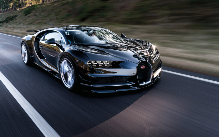 Black Bugatti Chiron driving on a road