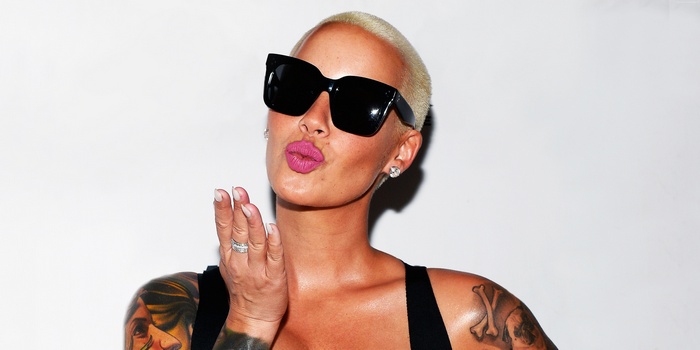 Amber Rose wearing sunglasses and blowing a kiss