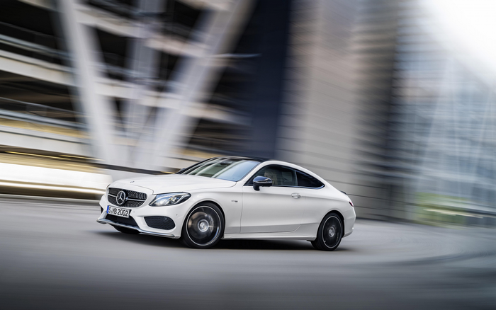 White Mercedes-Benz C43 AMG Coupe in motion