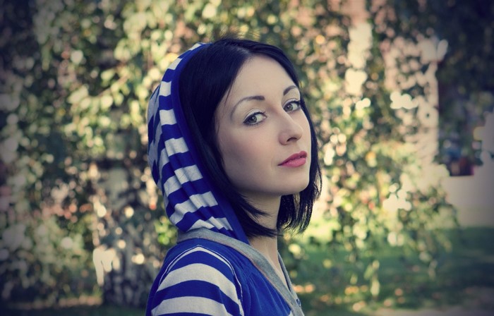 Woman in blue and white striped hoodie outdoors