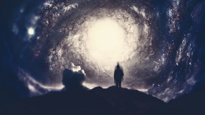 Silhouette of a person in front of a galaxy